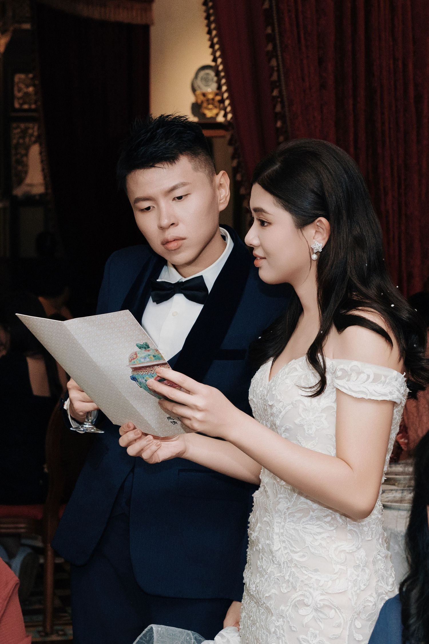Wedding couple reviewing their dinner menu inside Kebaya Dining Room