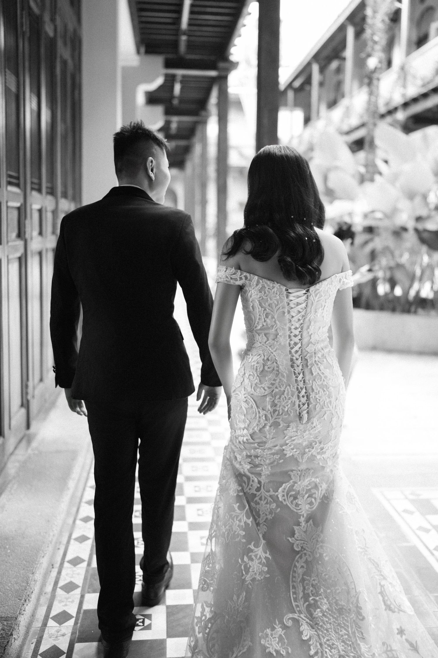 Couple walking through the historic Seven Terraces Penang hotel corridor for chinese tea ceremony