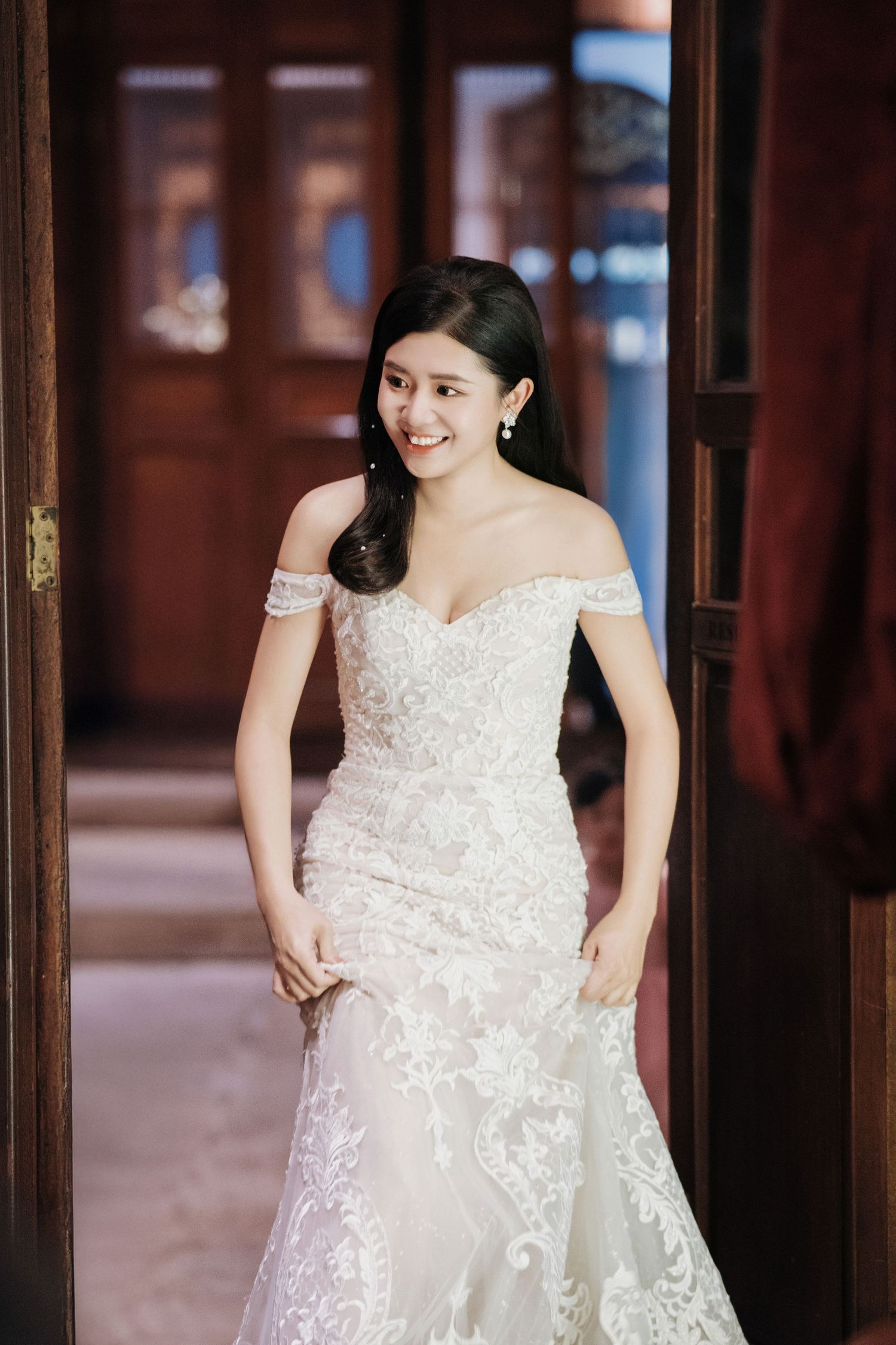 Bride entering the Kebaya Dining Room, Seven Terraces Penang heritage wedding venue in a white off-the-shoulder lace dress