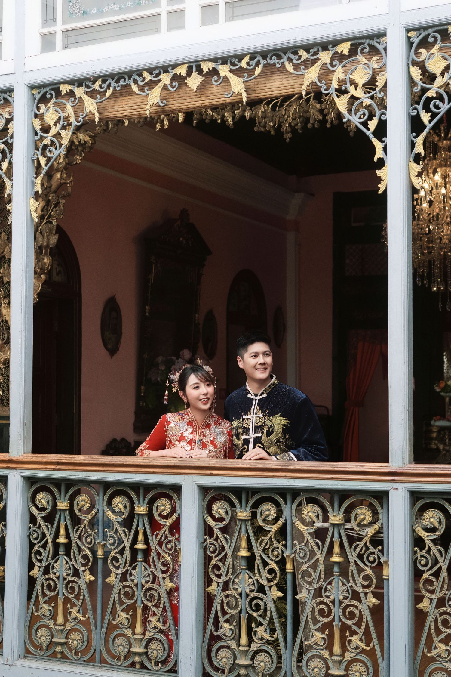 Close-up of modern traditional Chinese wedding attire including a red Qun Kwa and navy embroidered Changshan