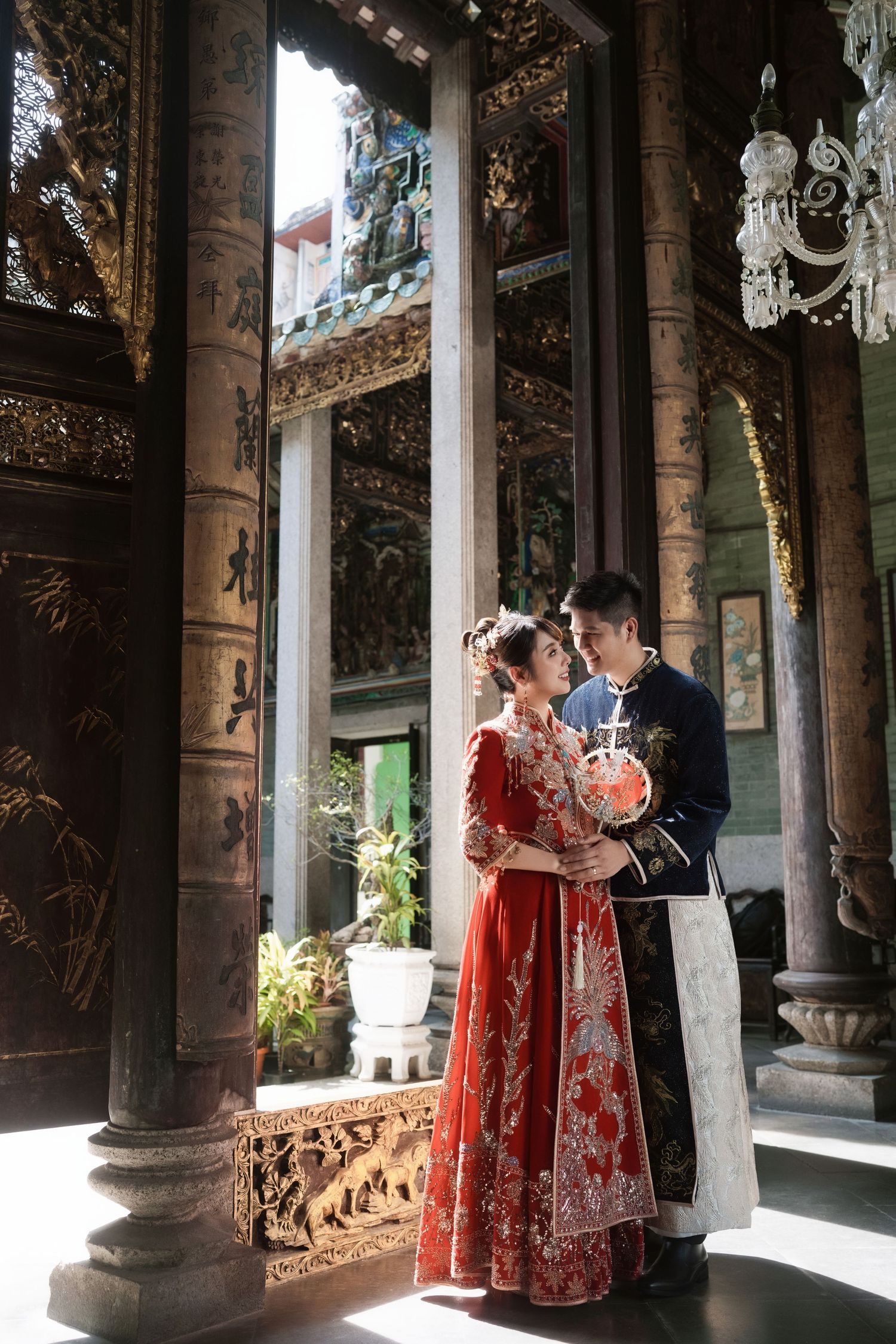 Heritage Chinese pre wedding photography featuring a couple in traditional Chinese embroidered attire at Pinang Peranakan Mansion