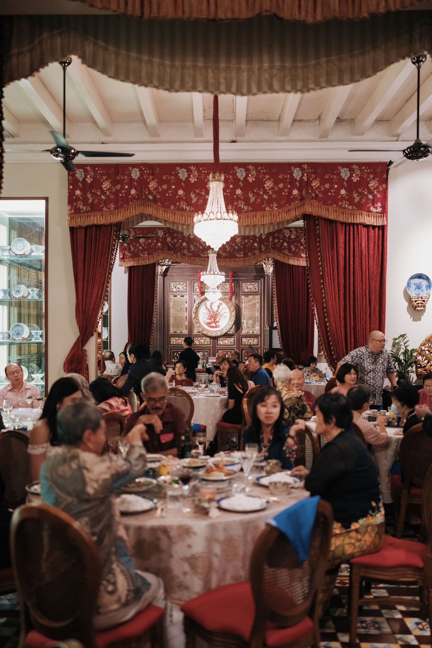 Wedding guests enjoying a grand banquet dinner under chandeliers at Kebaya Dining Room Penang