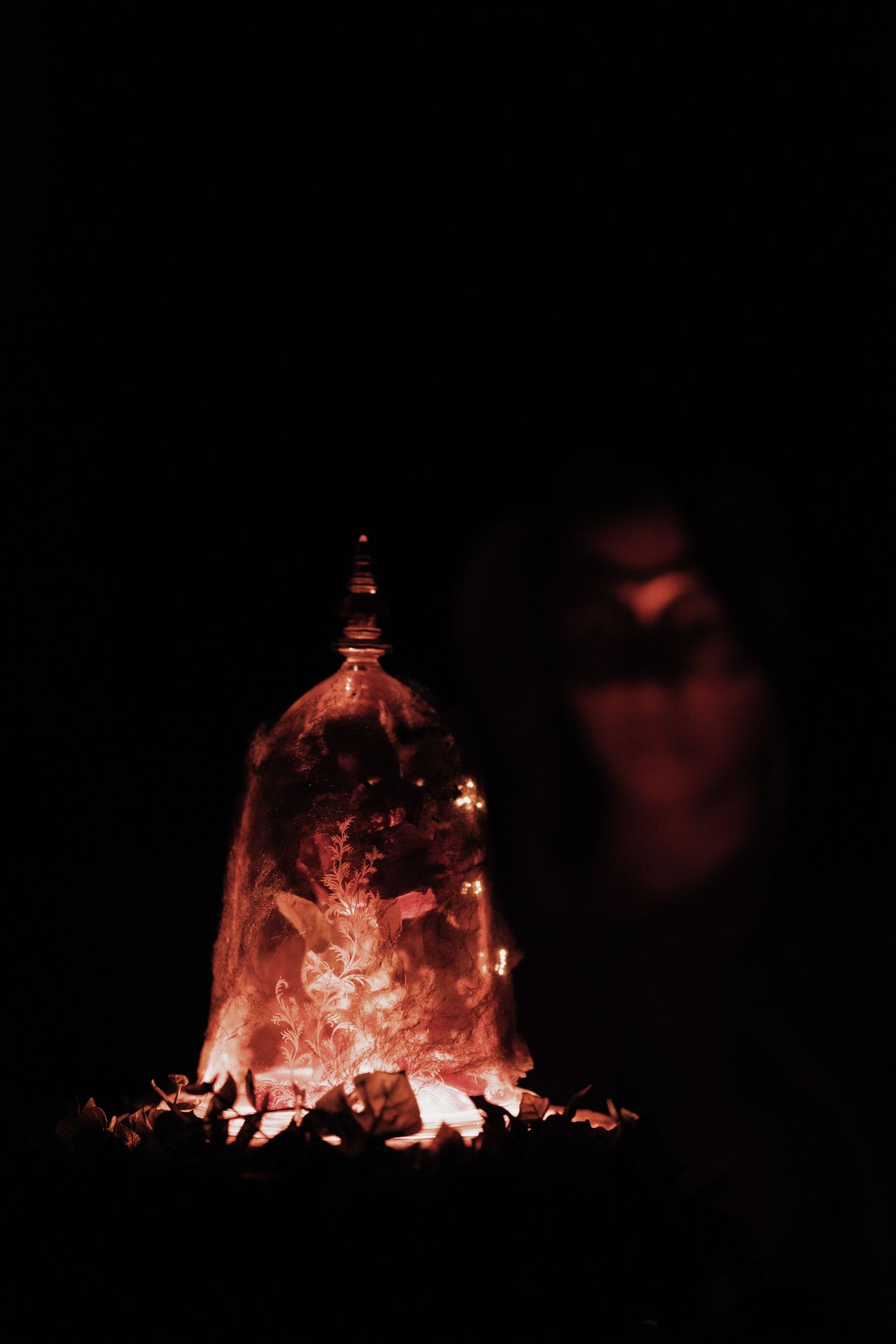 Glowing enchanted rose in a glass cloche, a magical centerpiece for a fairytale wedding theme