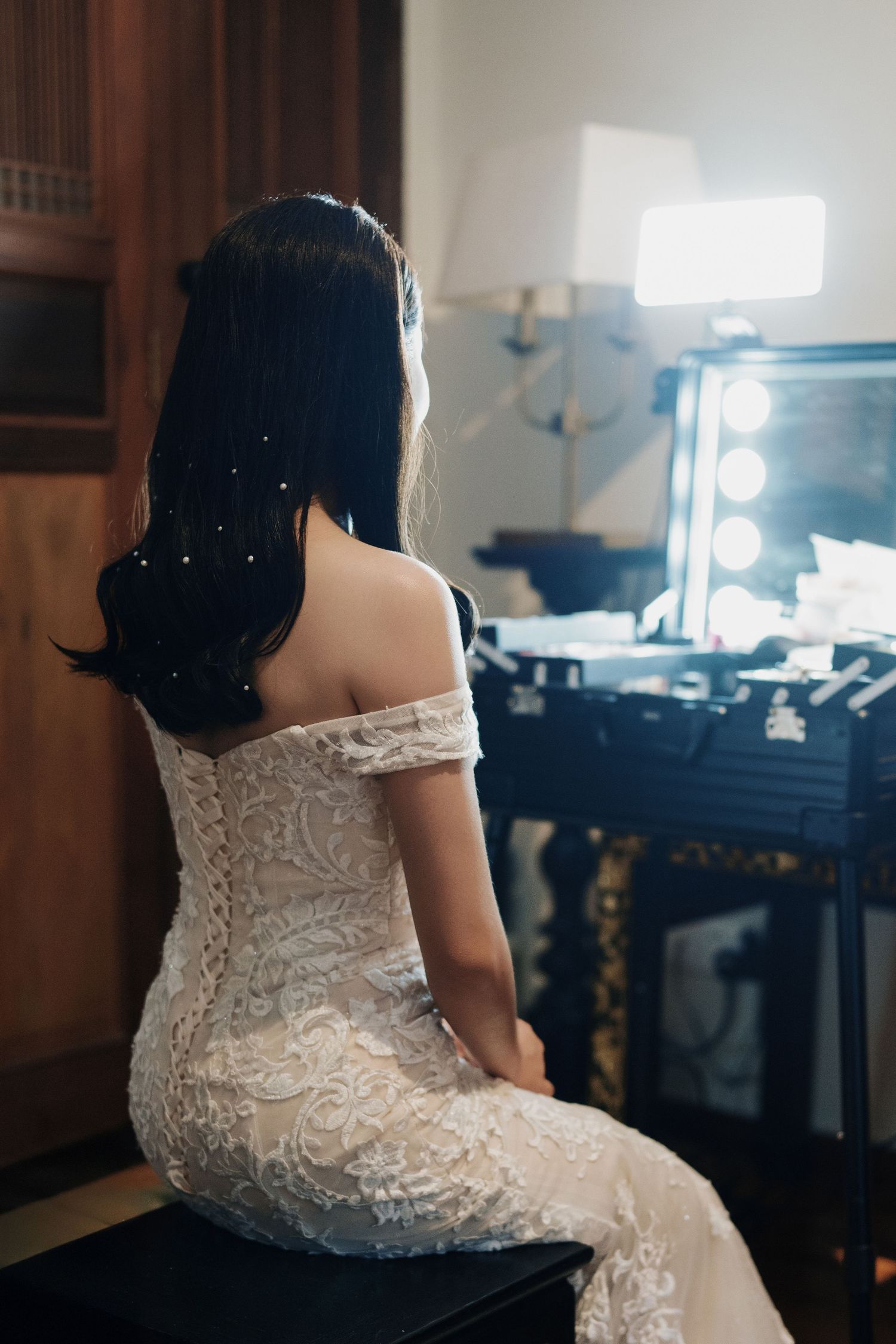 Bride getting ready for a Seven Terraces Penang wedding in a lace gown at a vintage makeup station