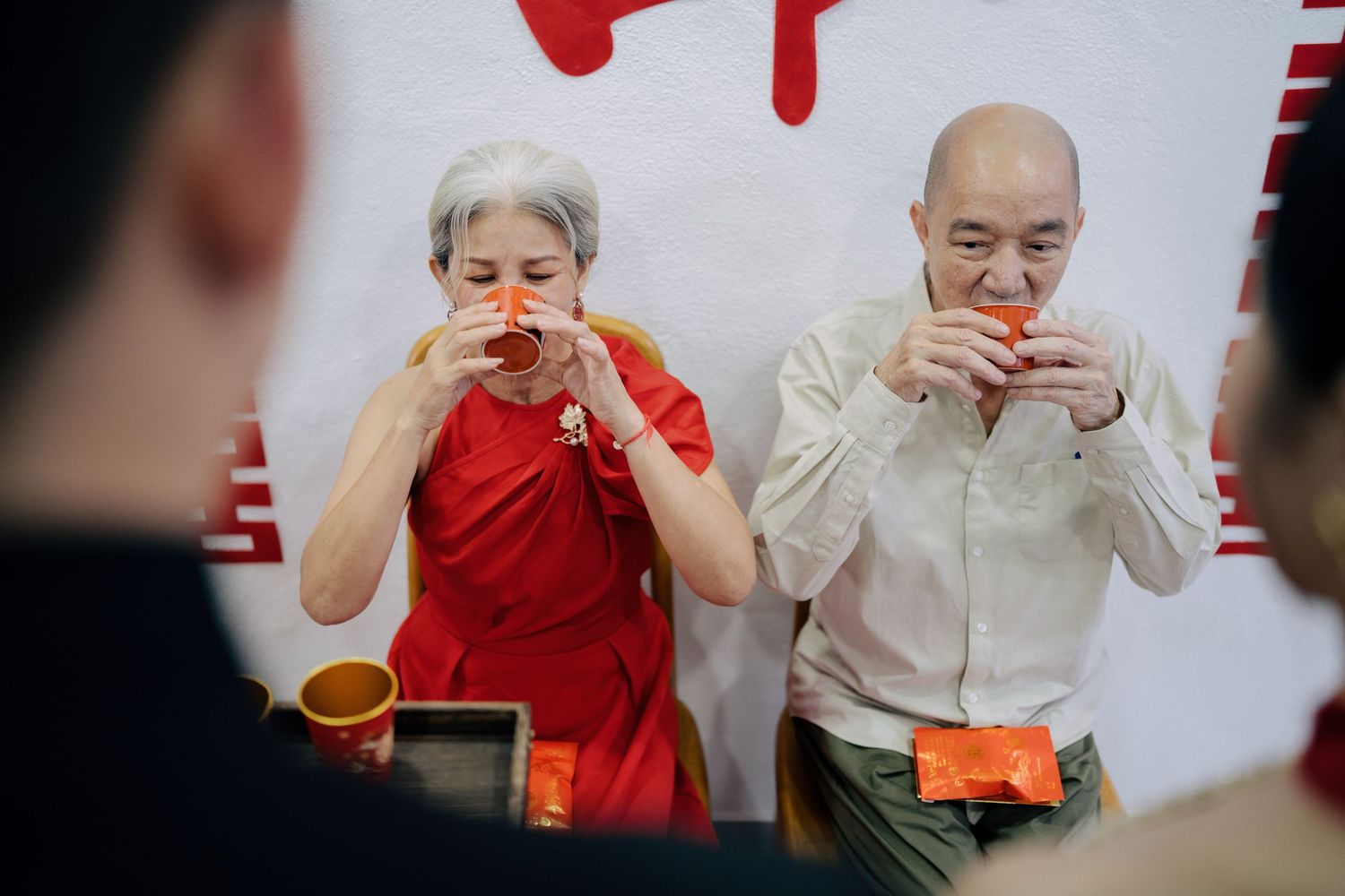 Parents drinking tea to bless the couple during a traditional Chinese wedding ceremony