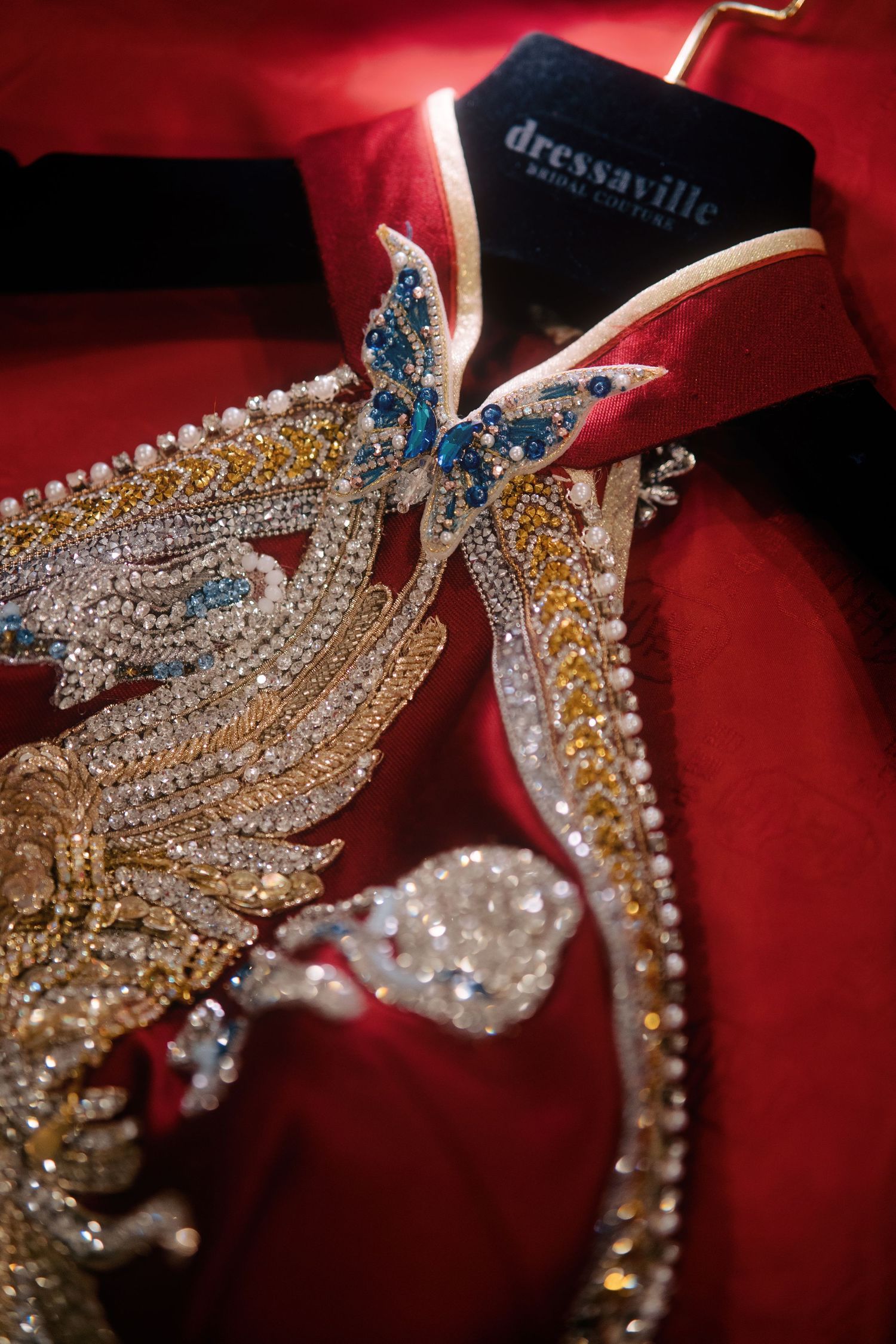 Close-up of the ornate embroidery on a red bridal Qipao, a staple of traditional Chinese weddings