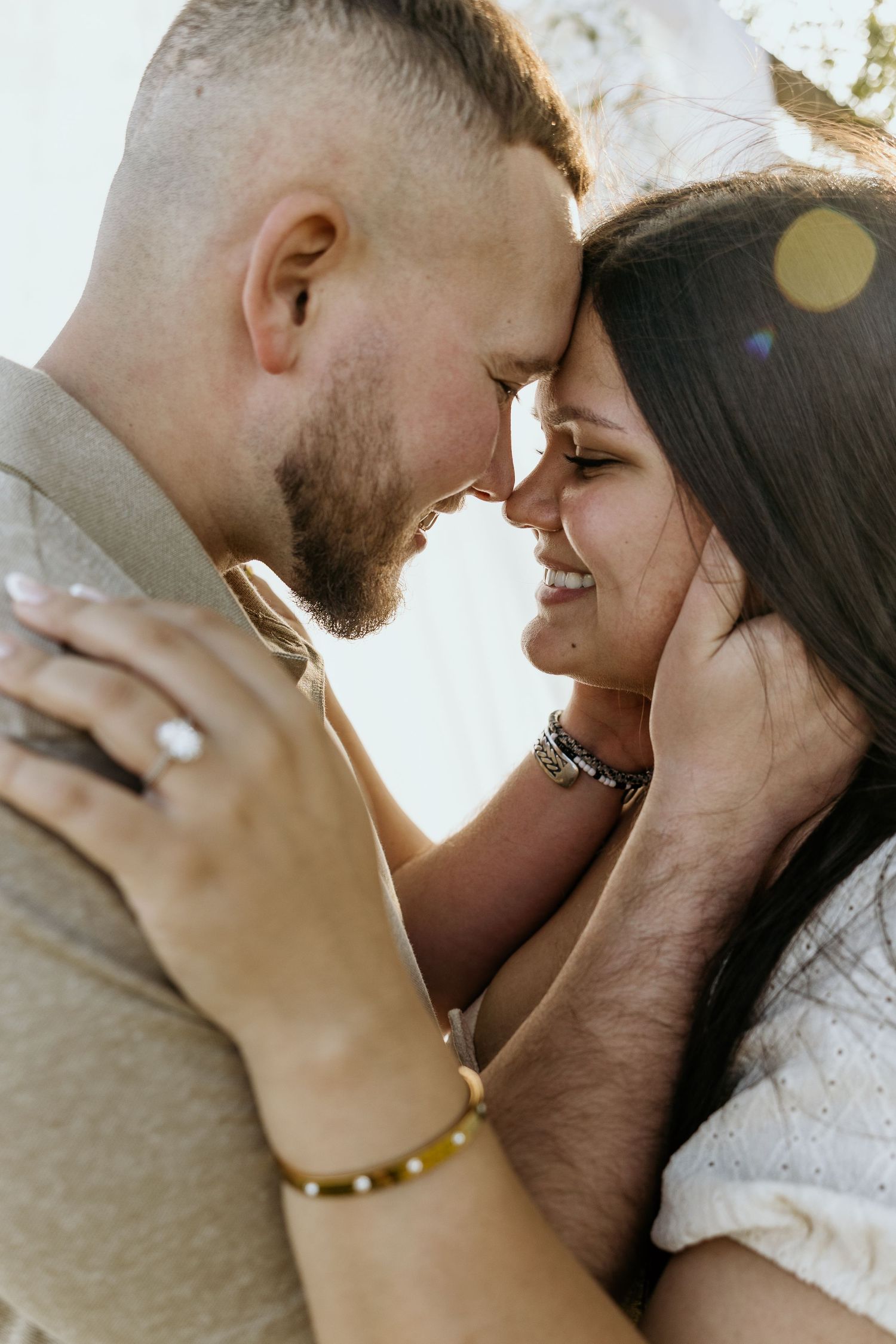 Intimate close-up portraits of couple sharing tender moments in bright sunlight.