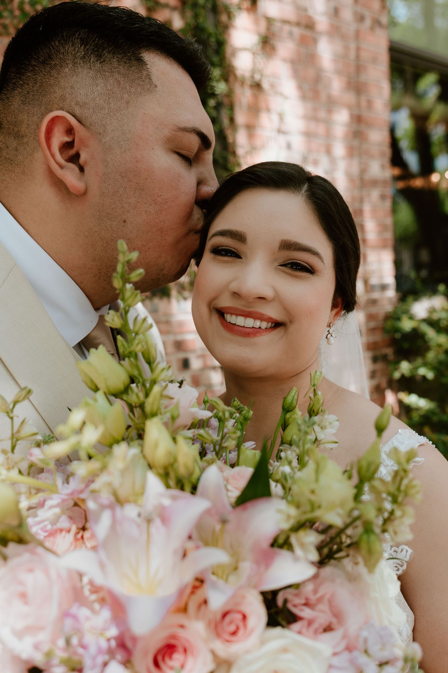 Romantic wedding moment with soft pink and white floral bouquet in natural light.