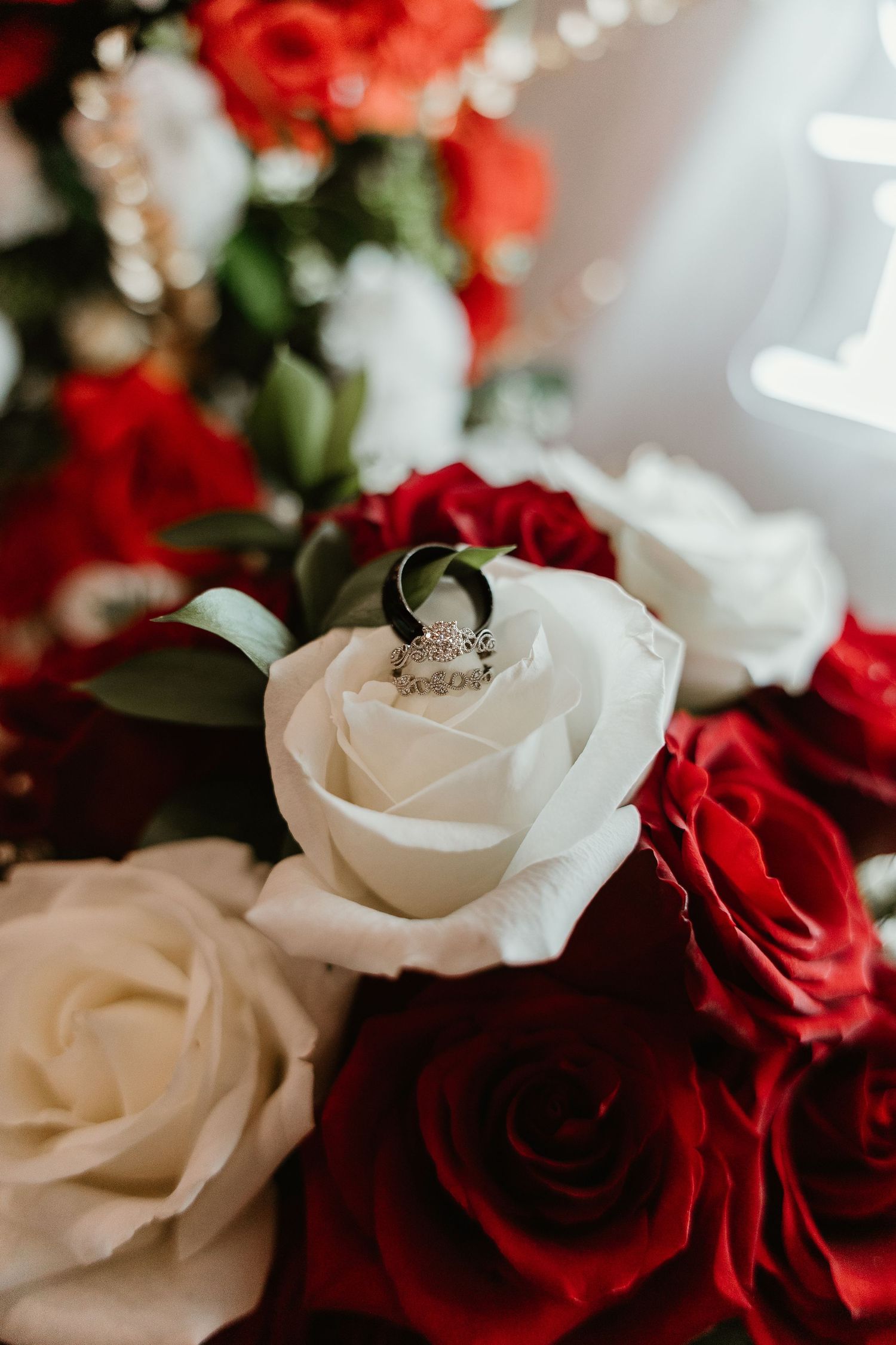 Close up of red and white roses in a wedding bouquet arrangement.