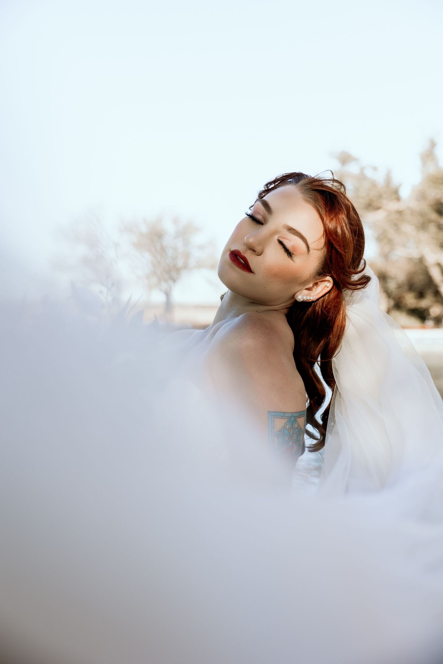 Dreamy bridal portrait with soft focus and ethereal lighting creates romantic atmosphere.