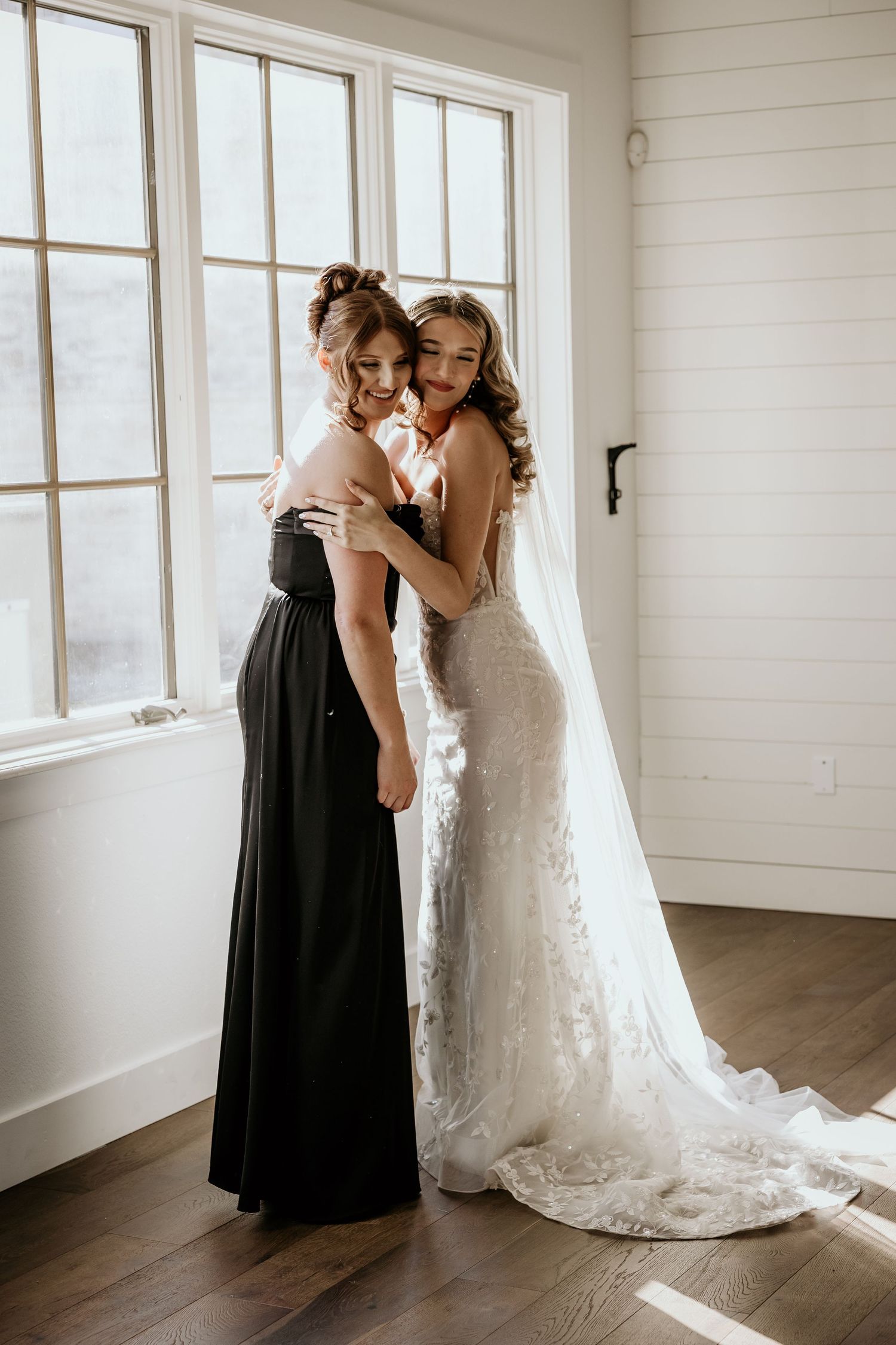 Emotional first look between bride and maid of honor.