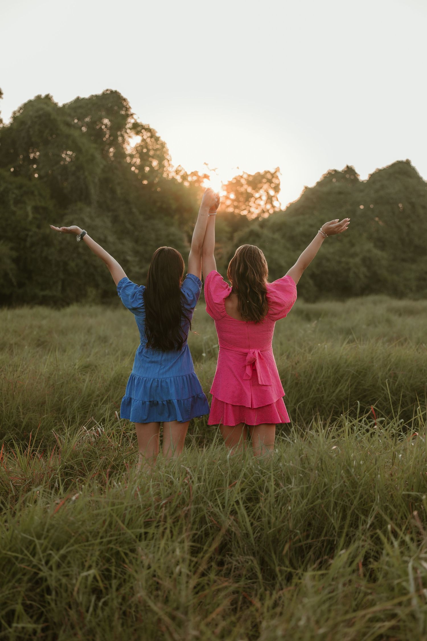 Senior bestfriend session during sunset in an open field.