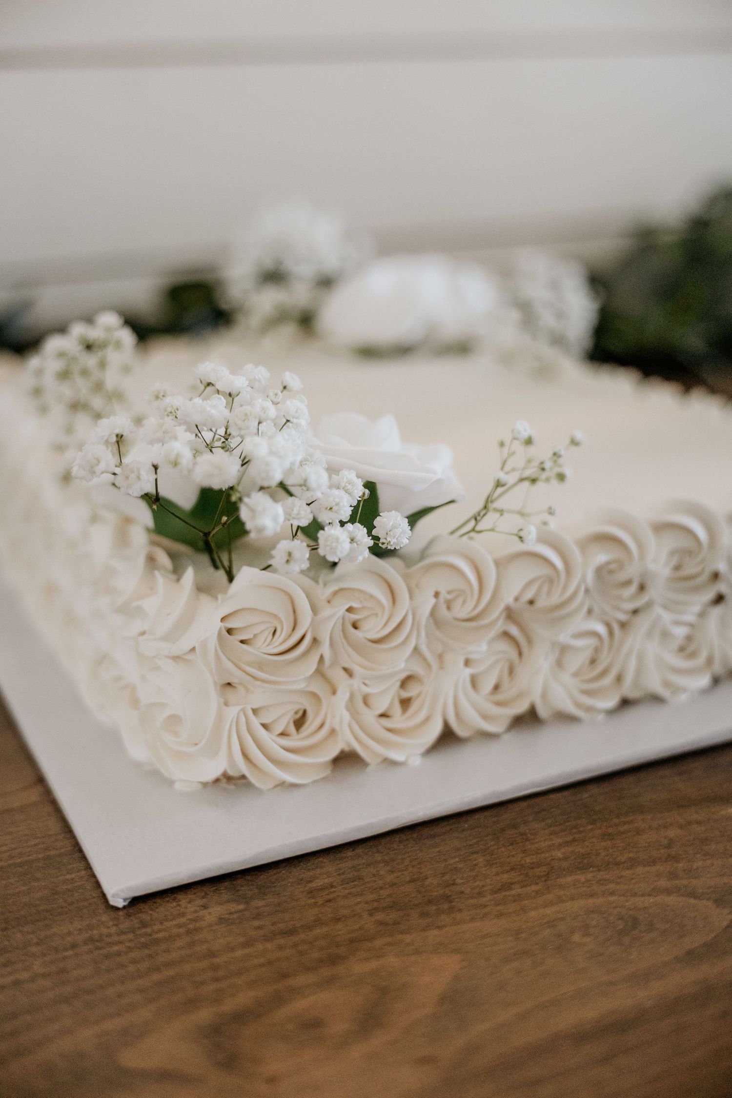 Wedding sheet cake with elegant swirls and baby's breath florals.