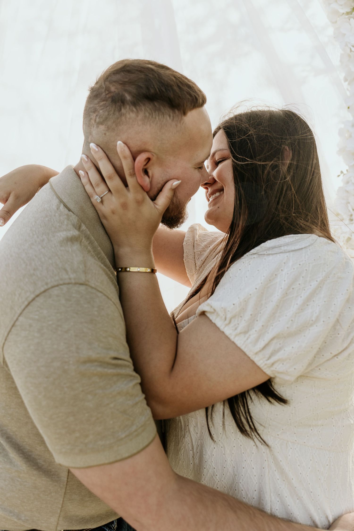 Romantic close-up shots of couple embracing in soft natural light.