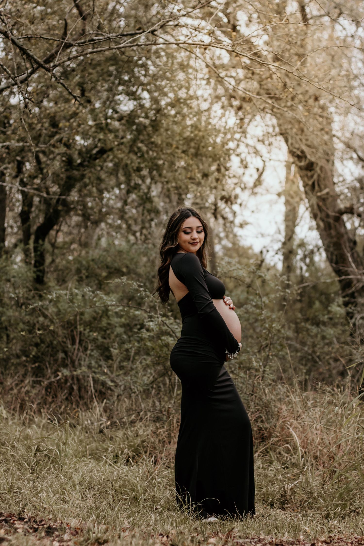 Maternity portraits in a dreamy woodland setting captured by Whispering Willow Collective LLC.