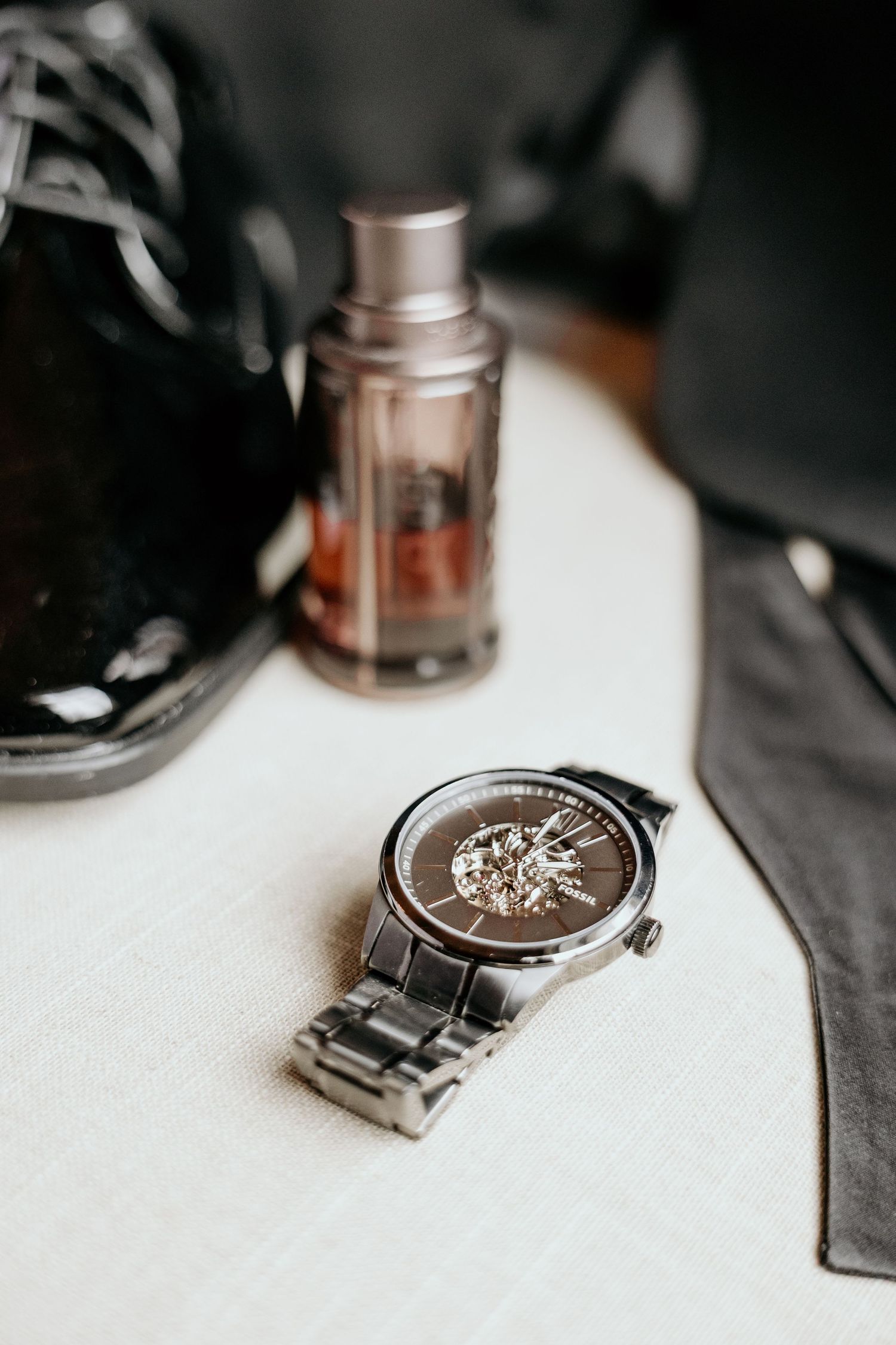 Close up of elegant silver watch on white surface.