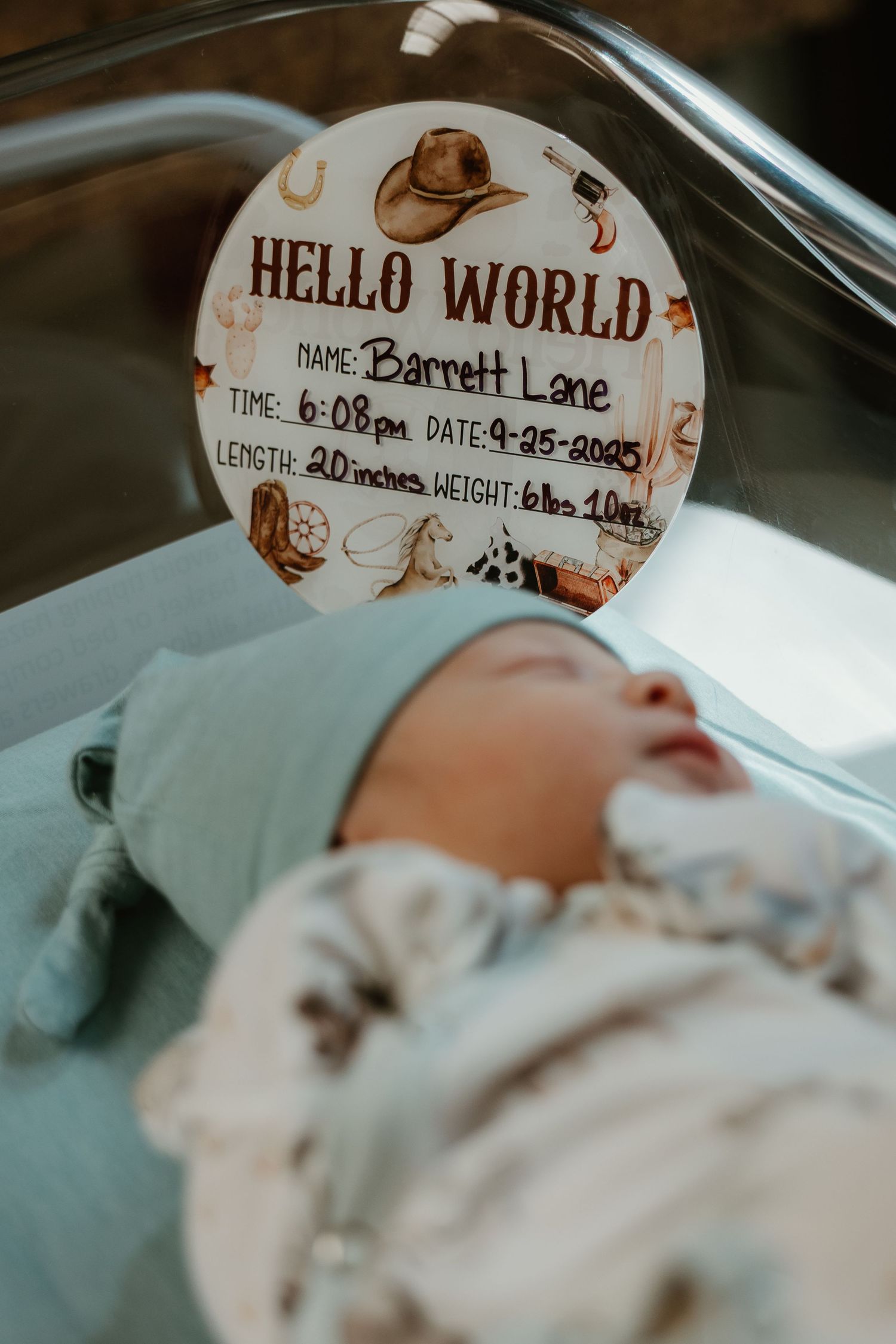Hospital name tag reading 'Hello World' with baby information.