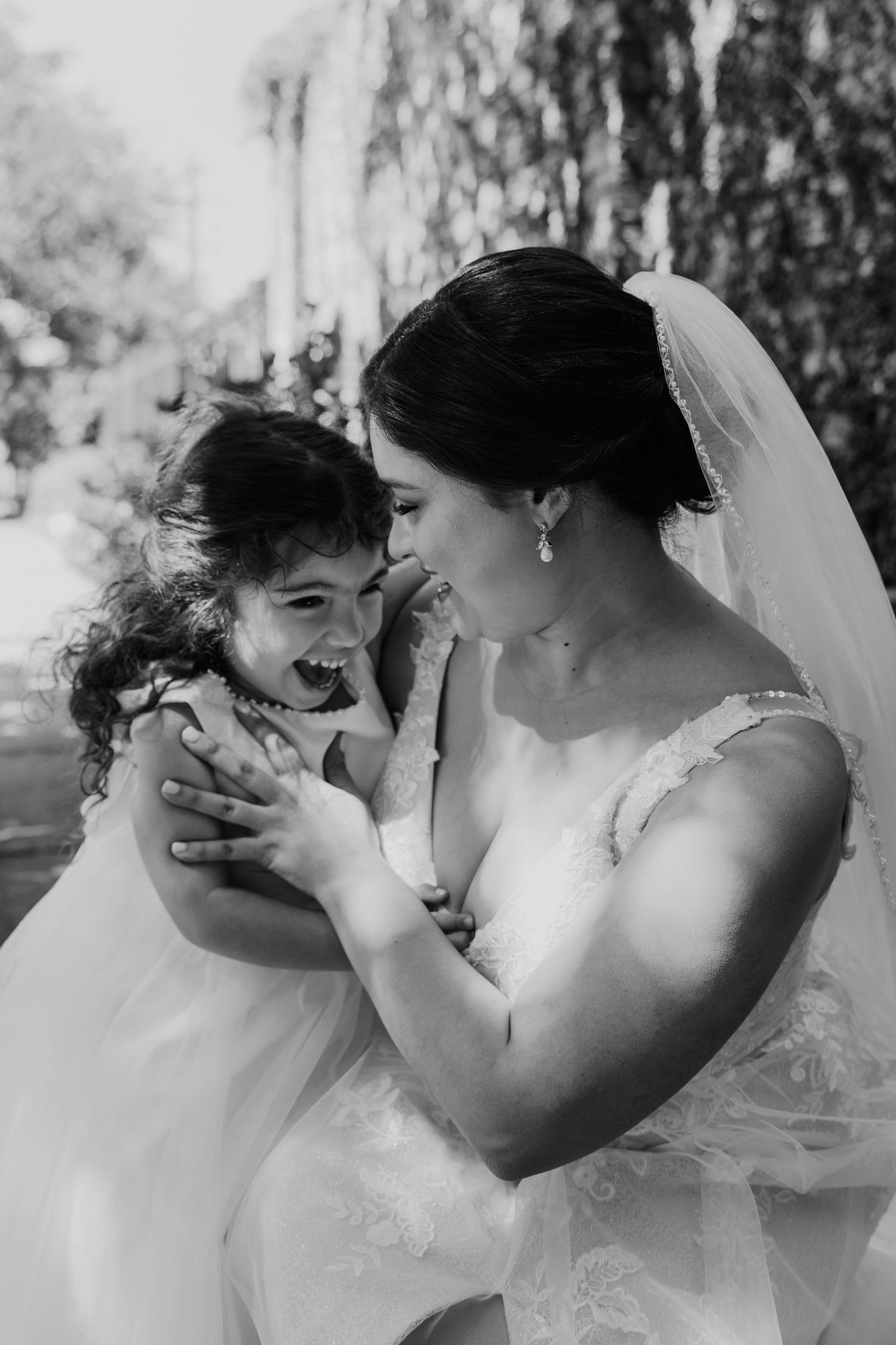A tender black and white moment between a bride and flower girl.