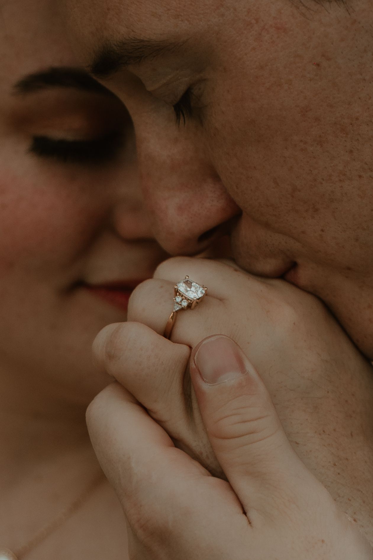 A close-up shot of an engagement ring during an intimate moment.