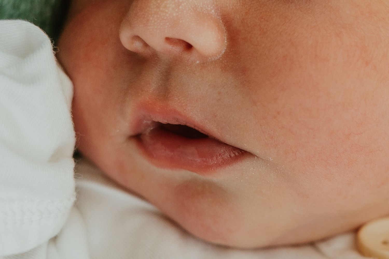 Close-up profile view of a sleeping newborn's features.