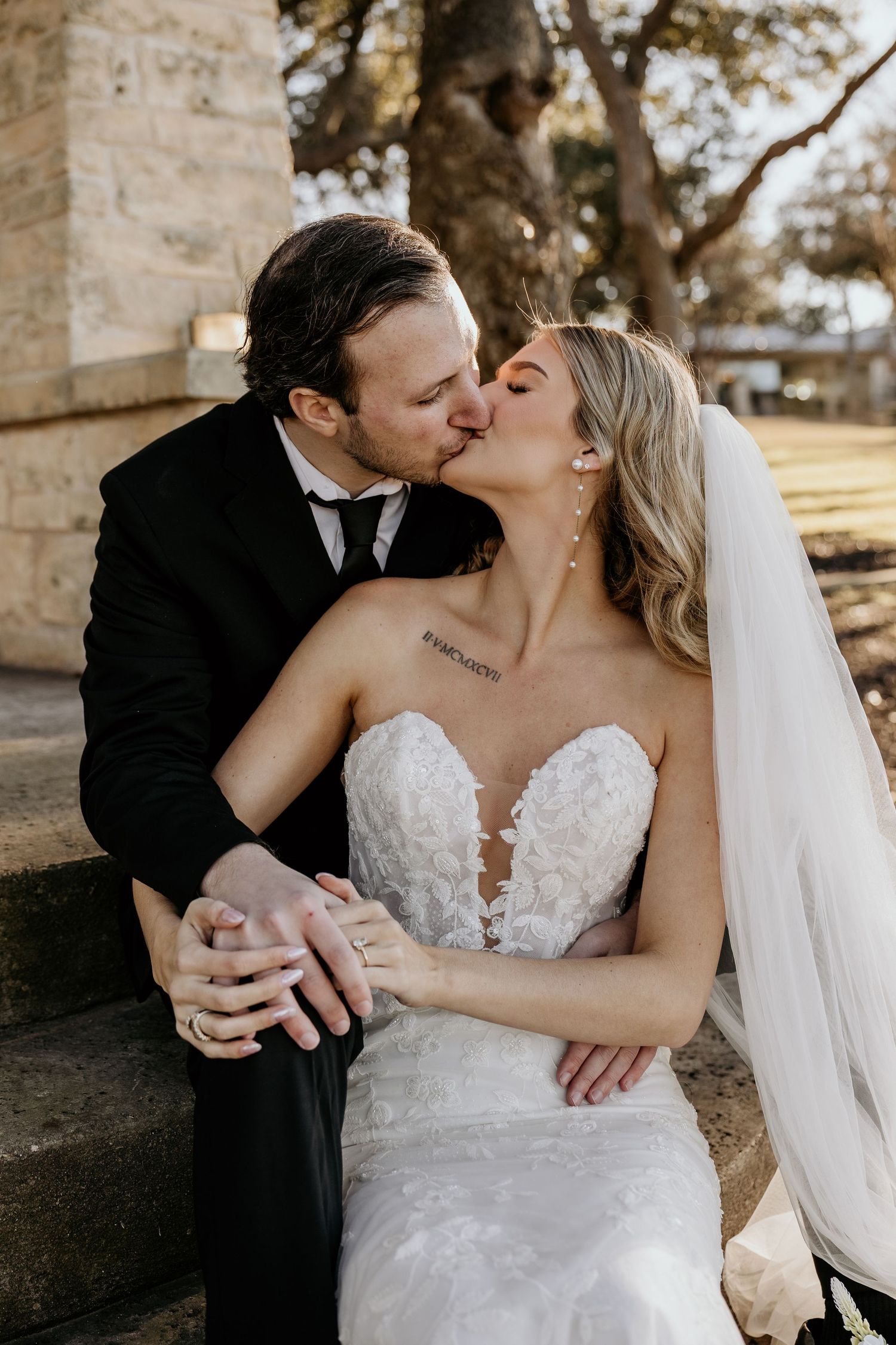 Romantic wedding couple share in each others embrace.