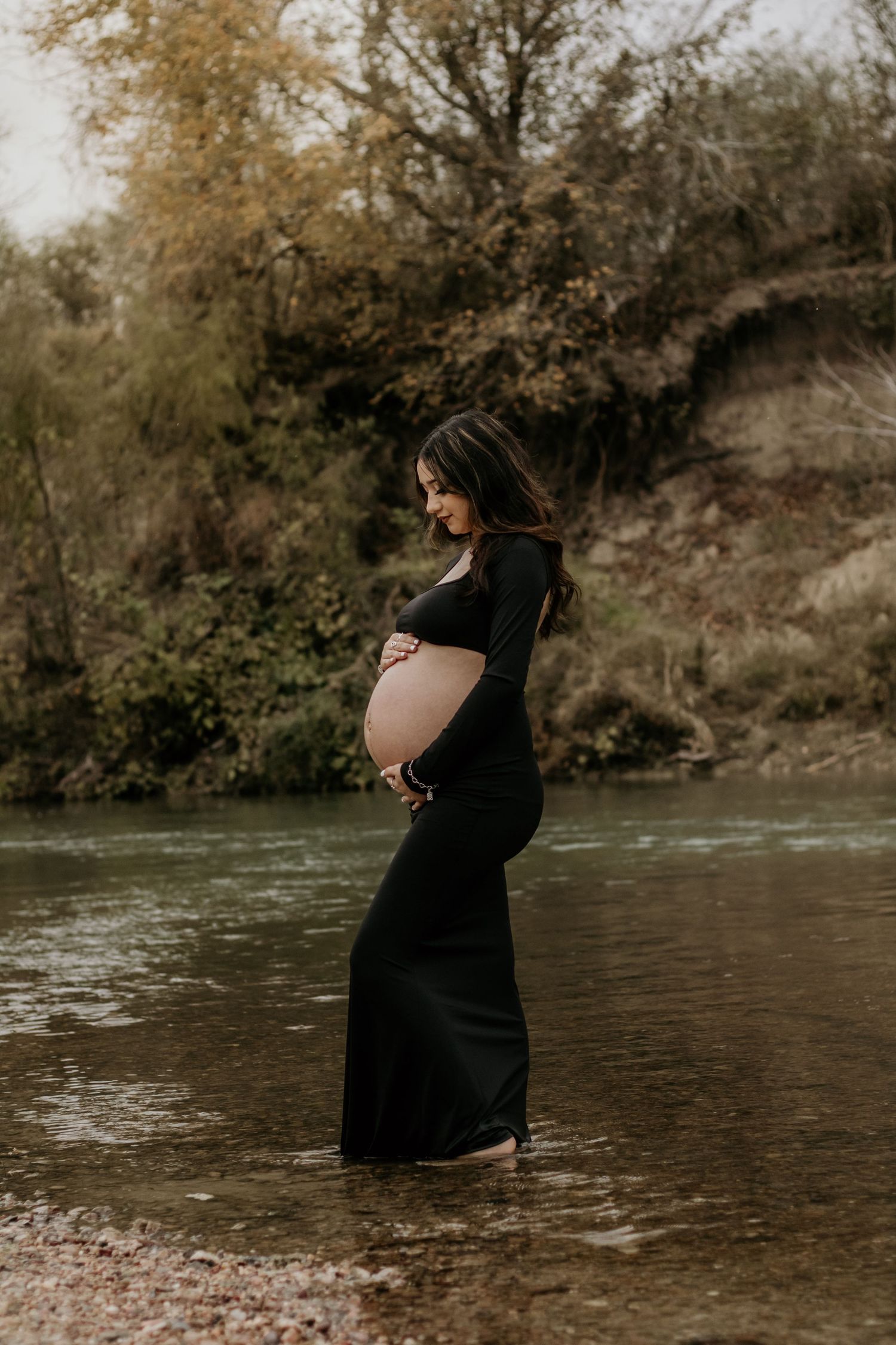 Ethereal maternity photos captured by a serene riverside at the Guadalupe river in Victoria, TX.