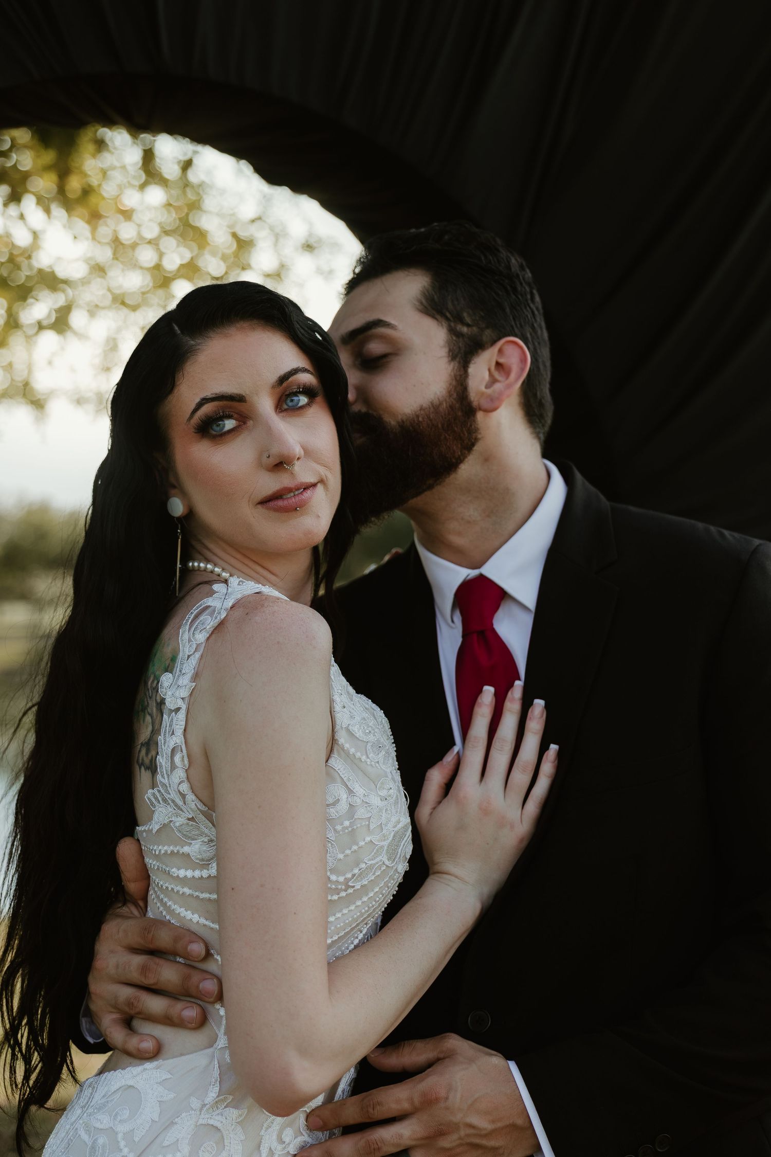 Intimate wedding portraits capture tender moments between couple in formal attire.