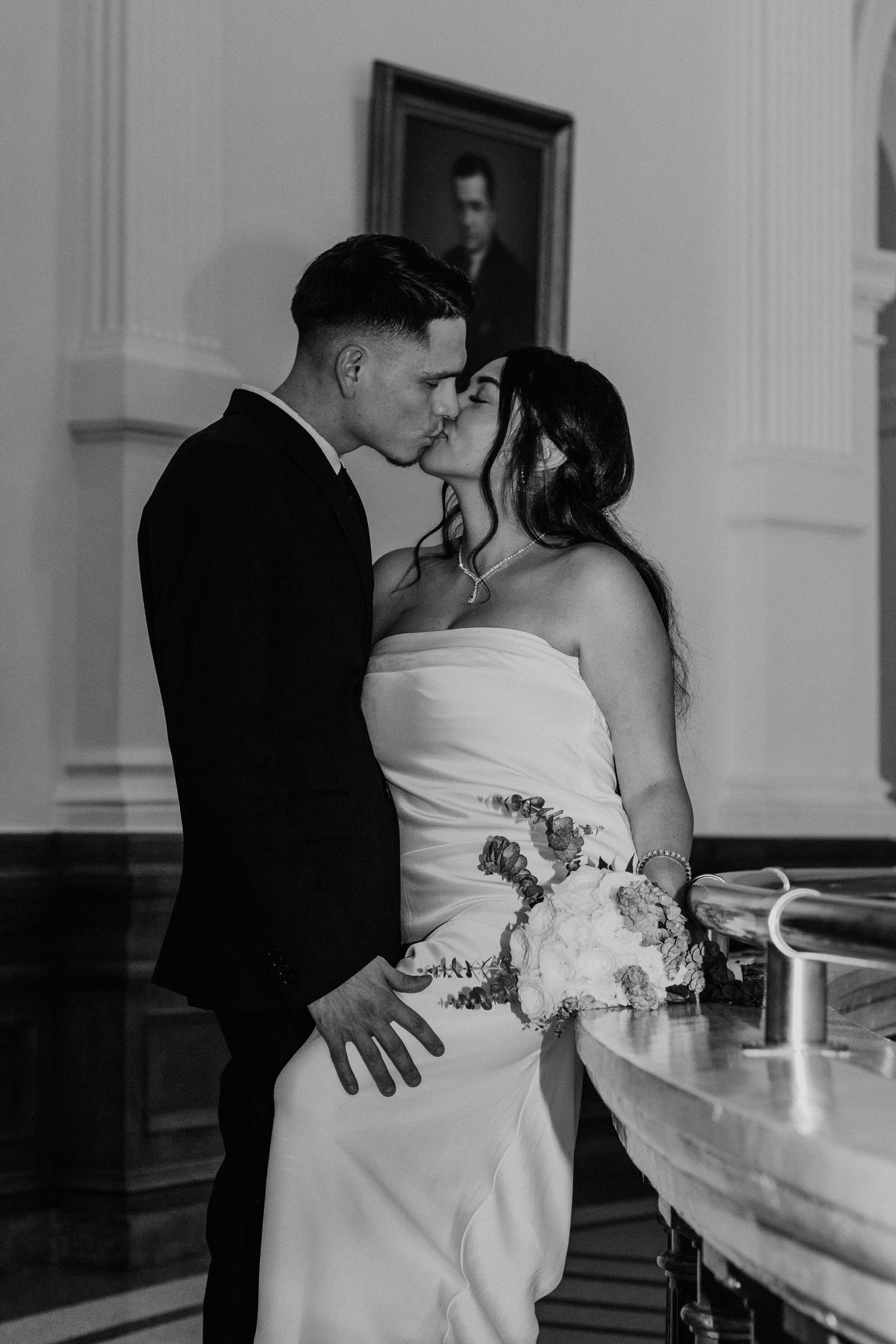 A romantic black and white wedding photo sequence showing a couple embracing near a window.