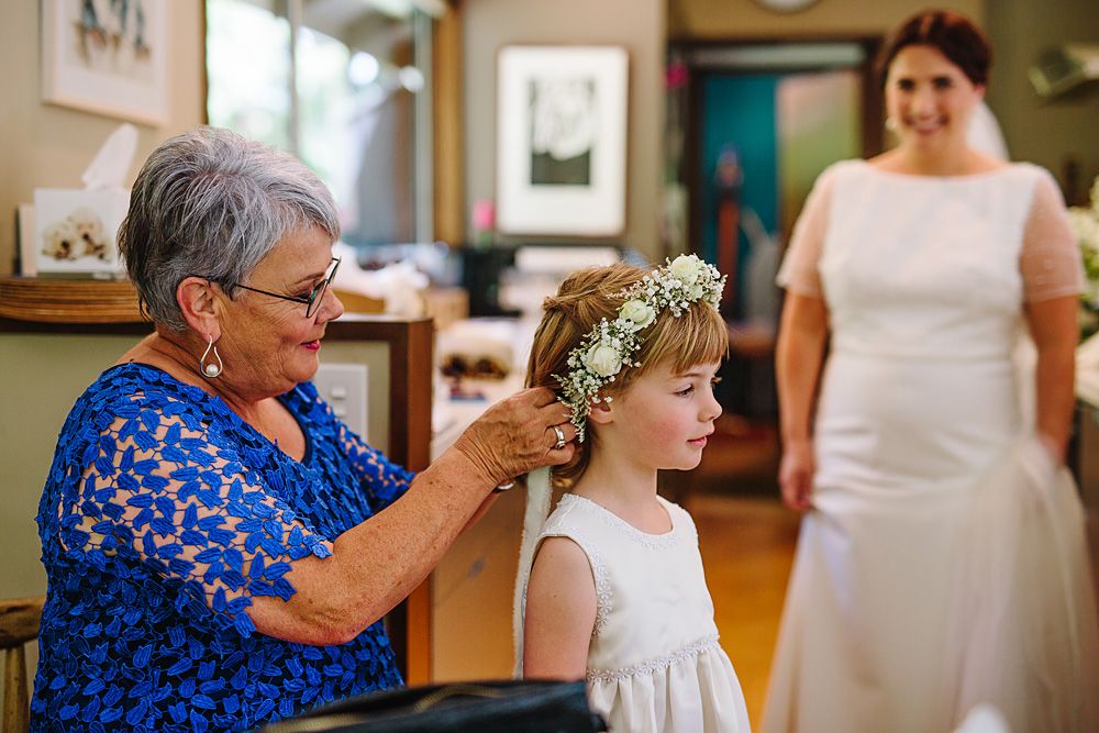 Wedding guests share emotional moments during an indoor celebration with elegant decor and floral arrangements.
