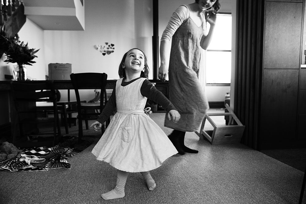 Black and white images capture playful dancing and movement indoors.