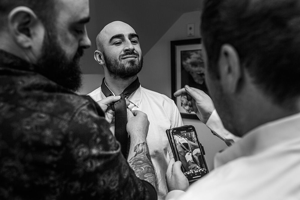 Black and white candid moments captured during wedding reception festivities.