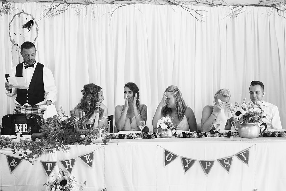 Elegant wedding reception setup with white decor and floral arrangements.