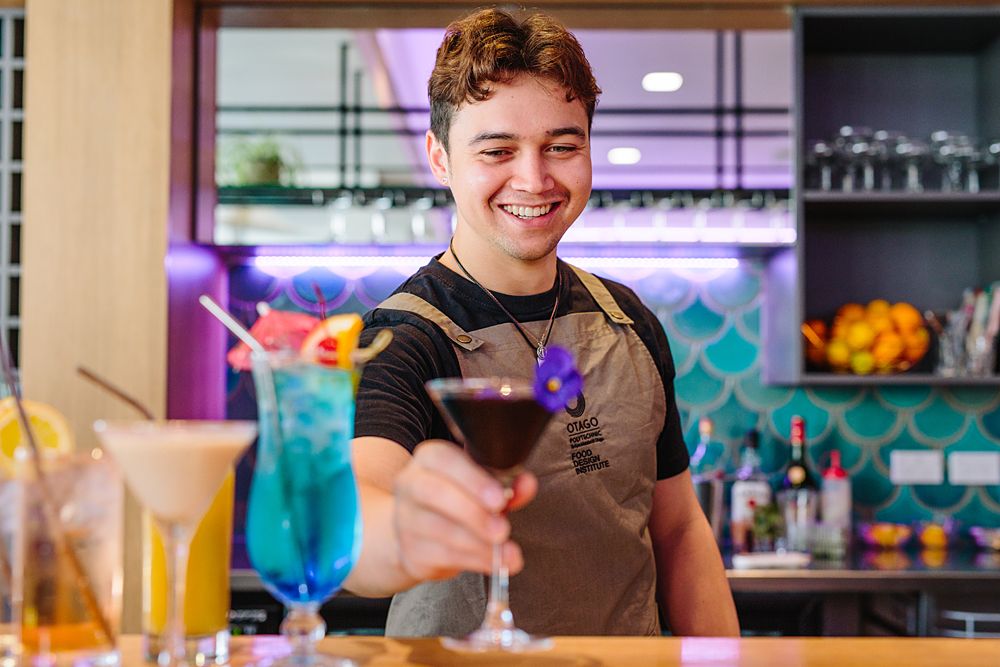Colorful cocktail bar scene with drinks and vibrant decor.