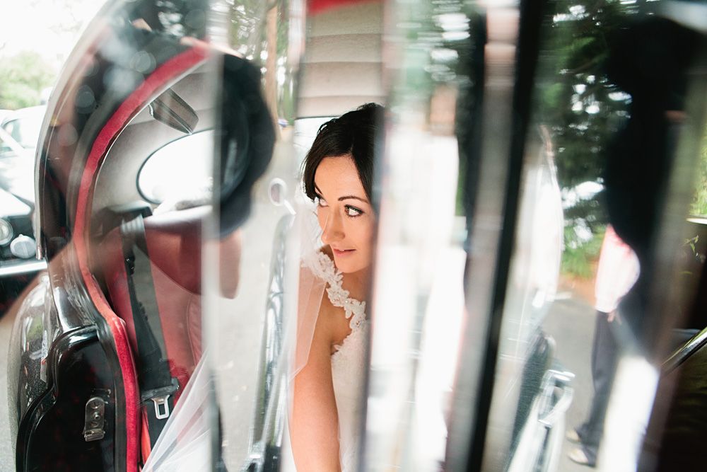 Wedding party getting ready in a car with smiles and laughter.