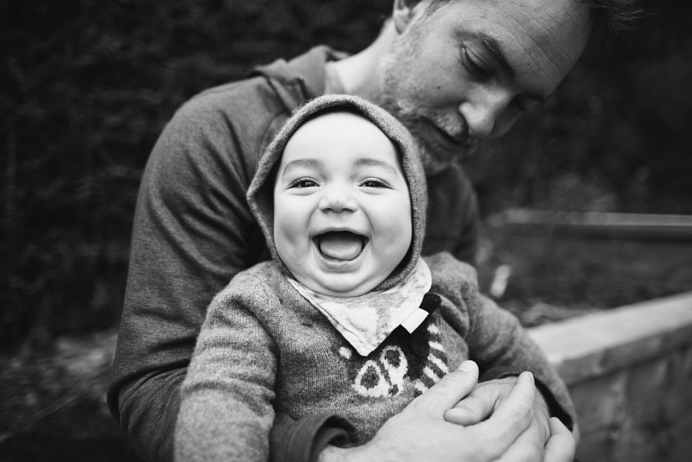 Black and white candid photos capturing genuine laughter and joy between family members.