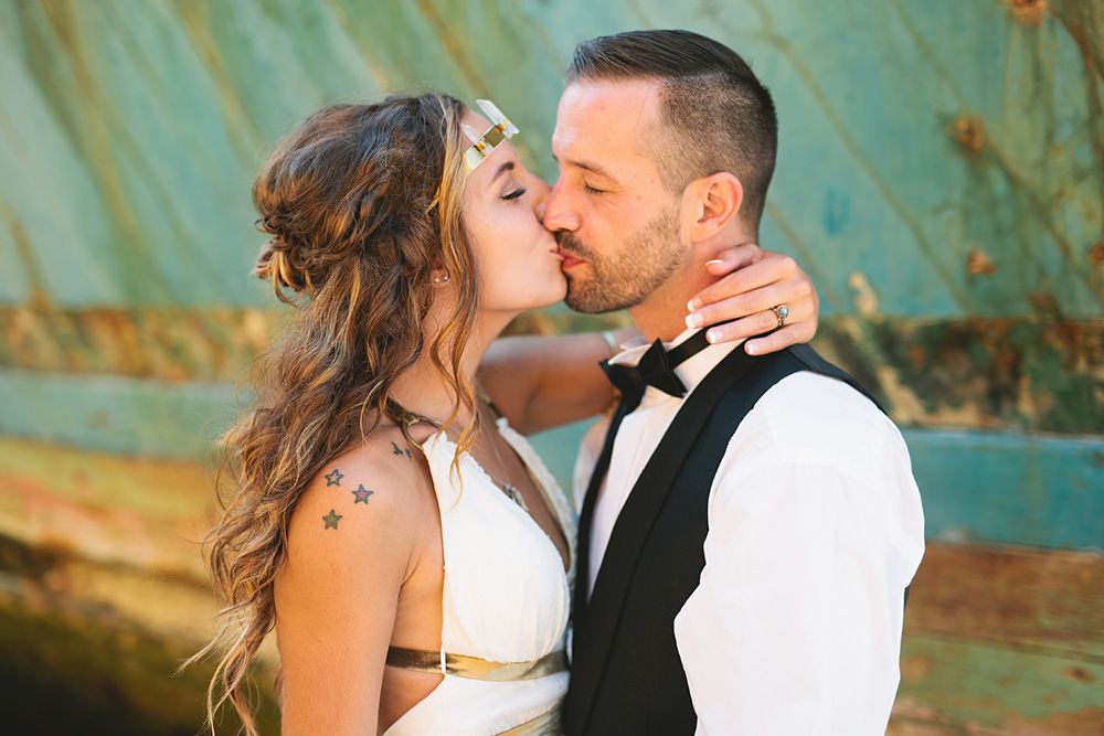 Romantic sunset wedding portraits against a turquoise rustic background.