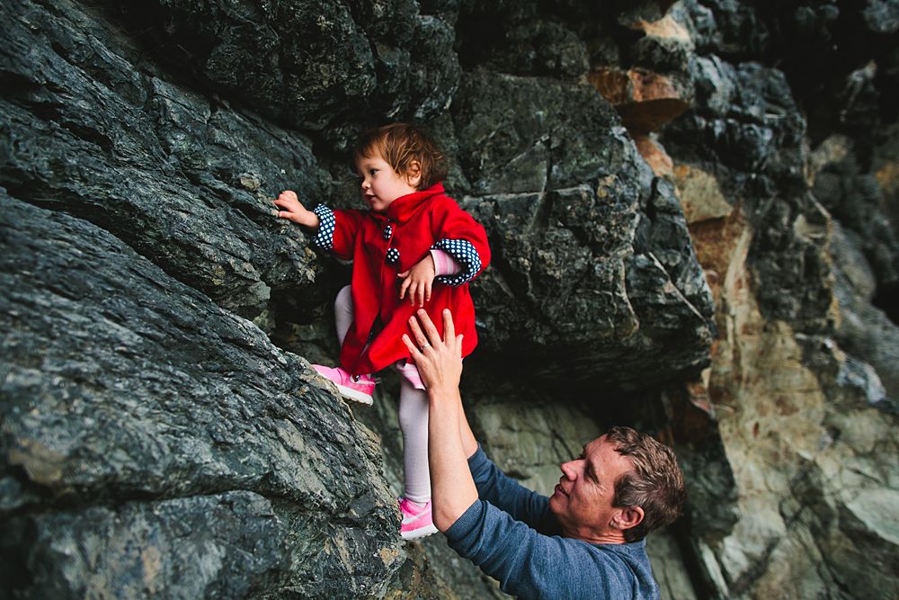 Family adventure photos against dramatic rocky cliffs and cave formations.