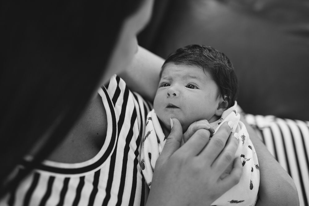 Black and white image showing gentle interaction with a small child.
