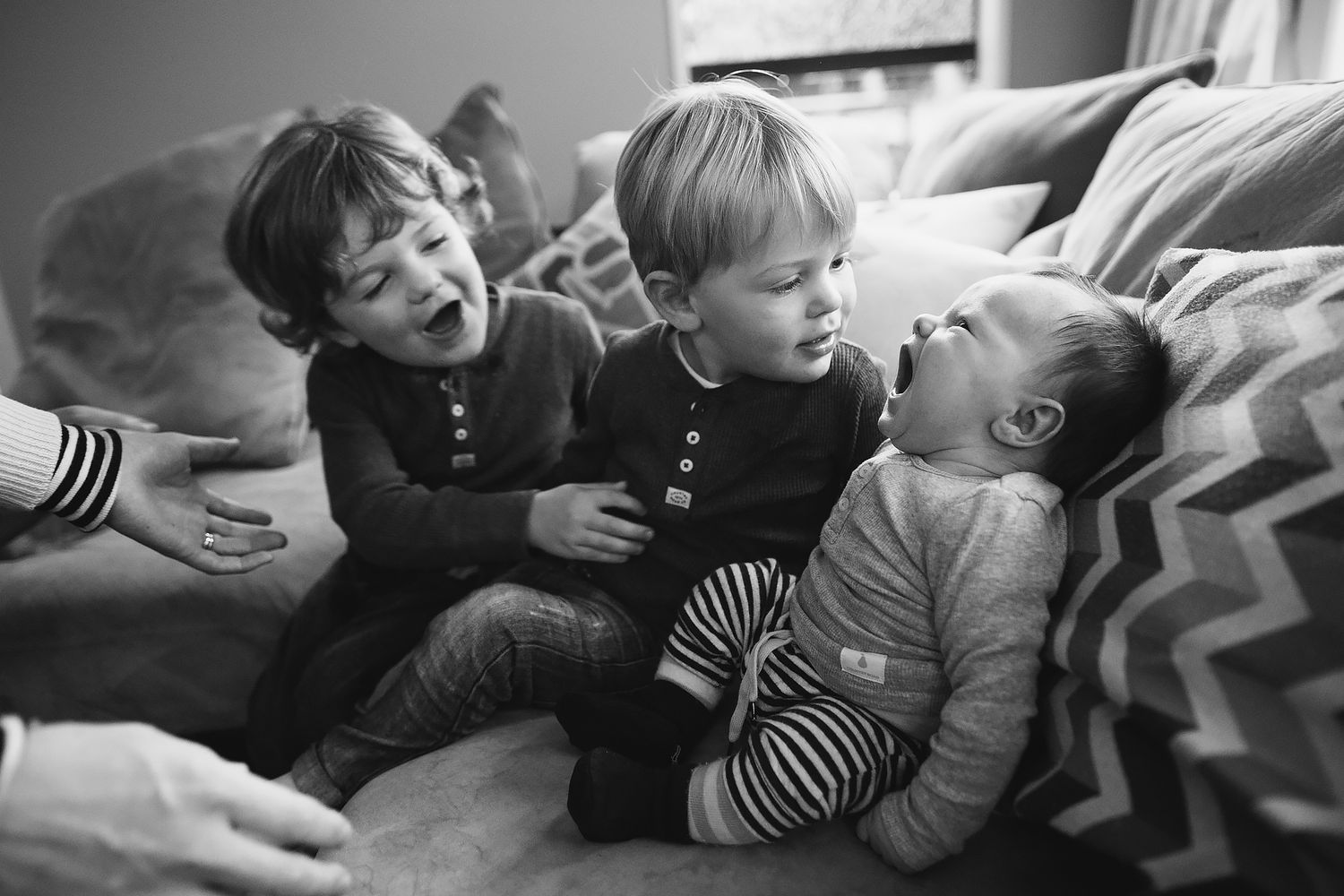 People relaxing together on a cozy couch with casual and playful expressions.