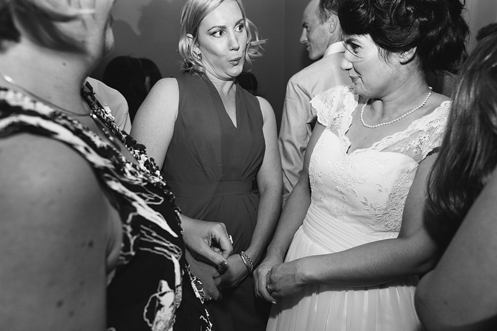 Black and white candid moments from a wedding reception.