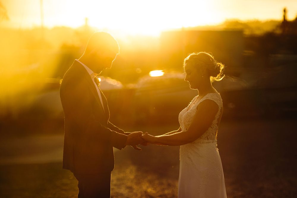 Golden hour silhouettes create romantic sunset portrait.