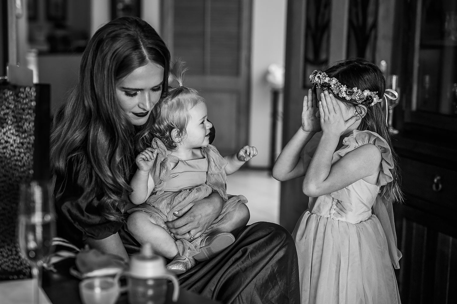 A black and white candid moment during wedding preparations.