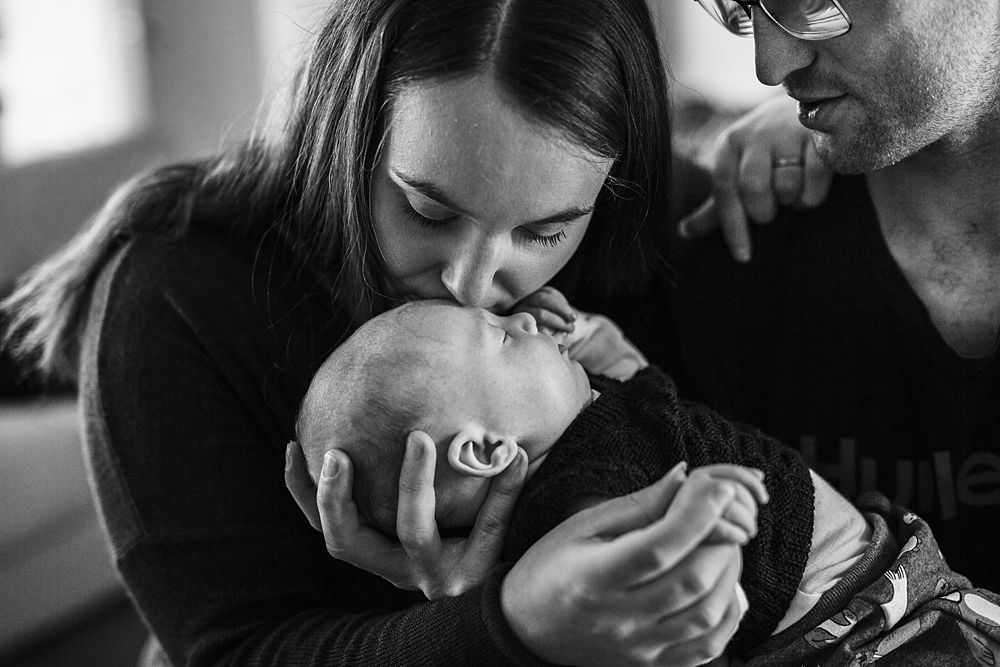 Intimate black and white photograph showing tender family interaction.