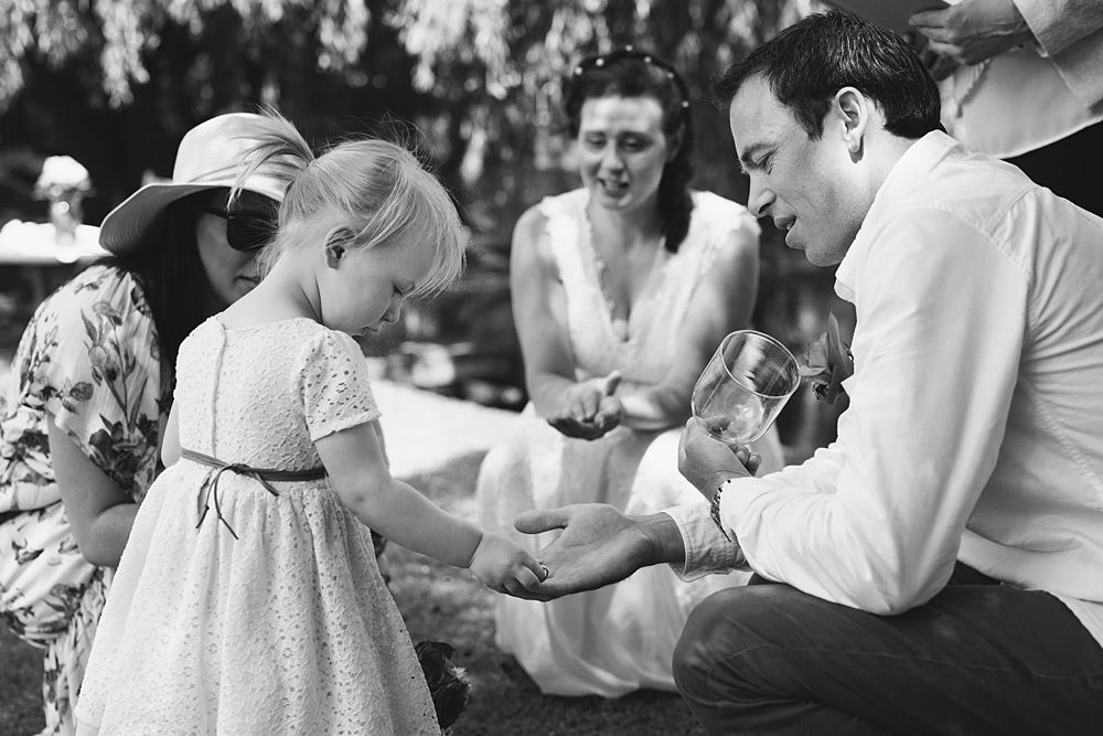 Black and white photo of wedding guests enjoying an outdoor reception.
