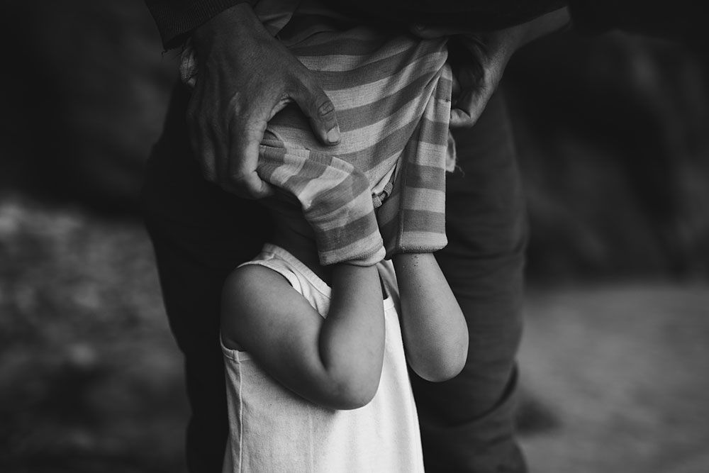 Black and white candid captures of playful family interactions.
