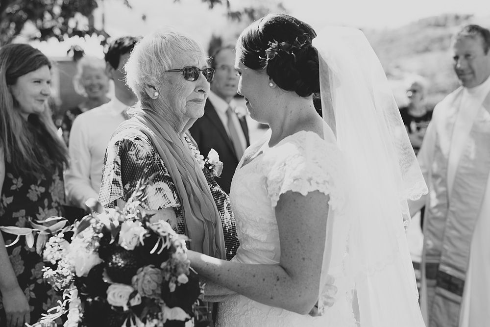 Outdoor wedding ceremony with guests gathered under sunny skies.