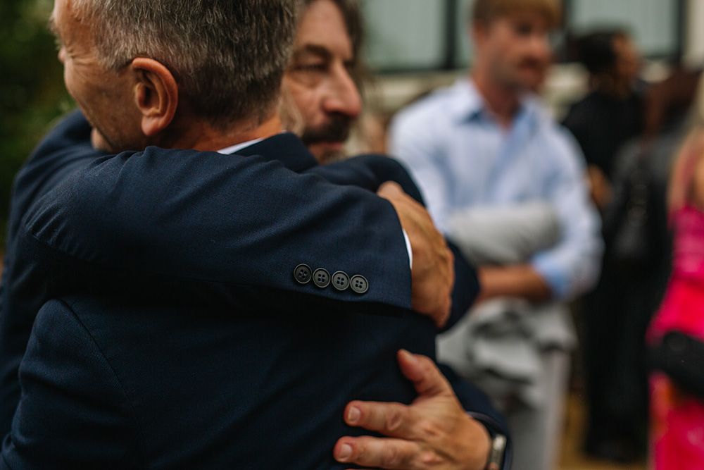 Emotional embraces shared during wedding reception celebrations.