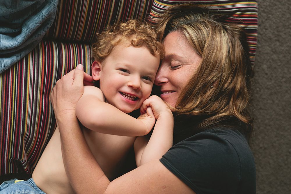 Intimate family photos showing affectionate moments on a striped couch.