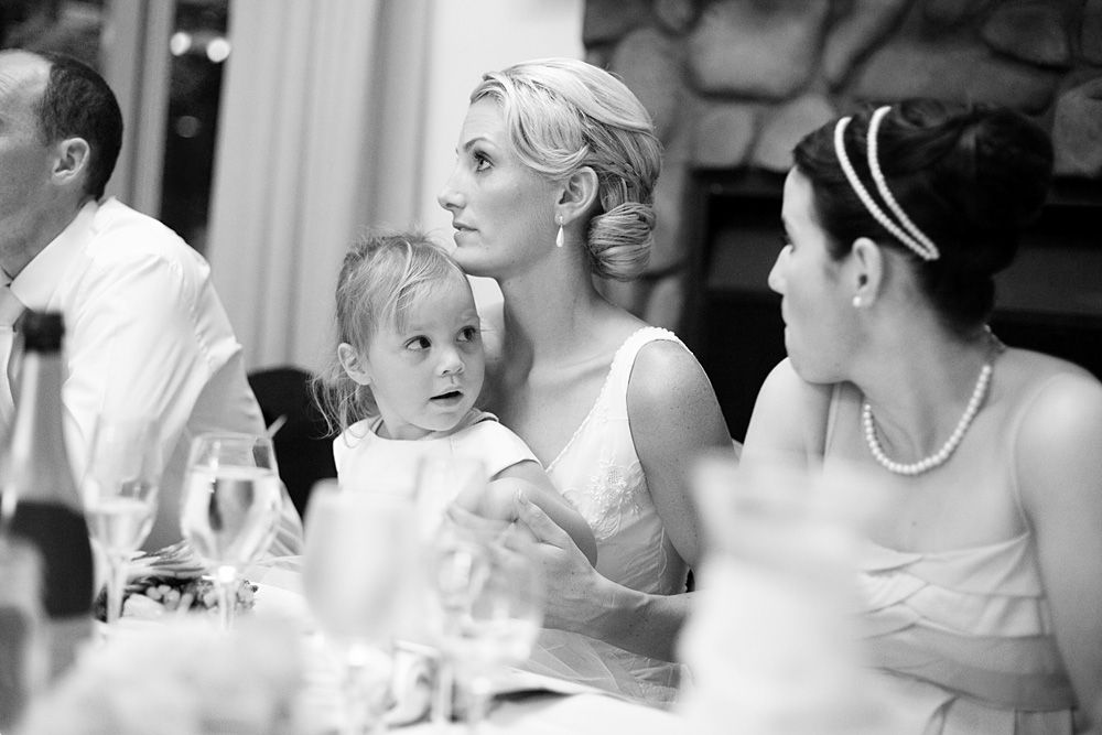 Candid black and white wedding reception moments with guests.