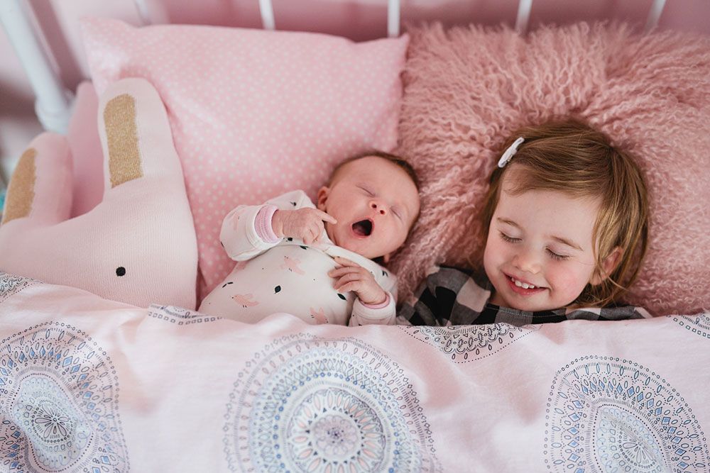 Sweet dreamy moments captured on pink bedding with soft plush decorations.